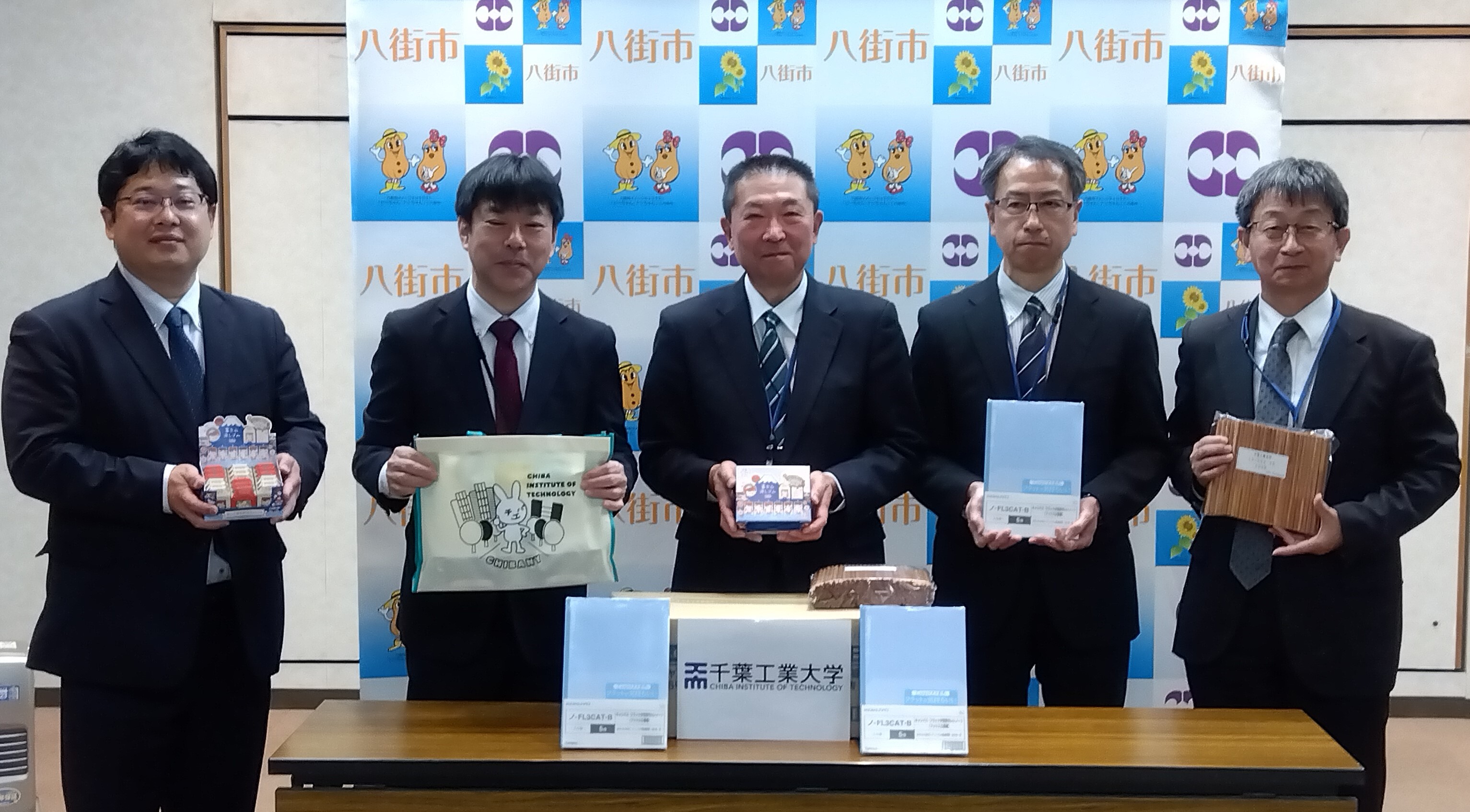 千葉工業大学より寄贈された文房具を受け取っている様子